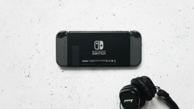 Nintendo Switch and headphones on a minimalist marble background, perfect for gaming content.