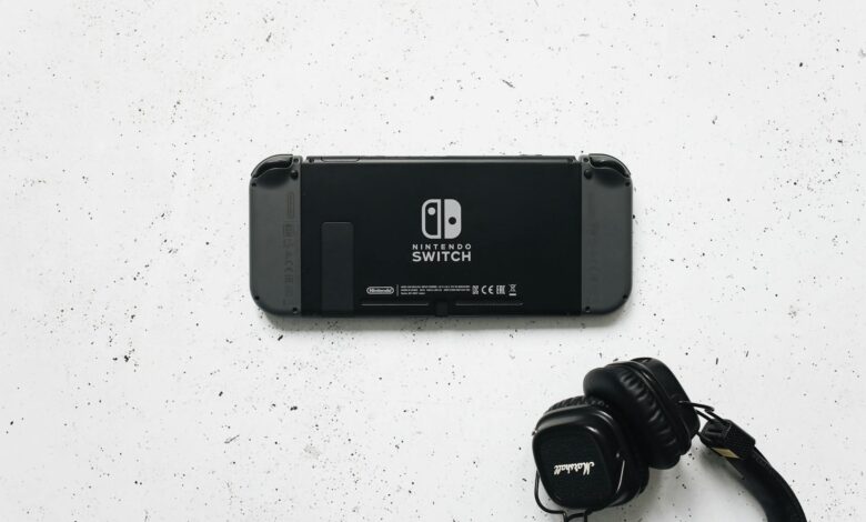 Nintendo Switch and headphones on a minimalist marble background, perfect for gaming content.