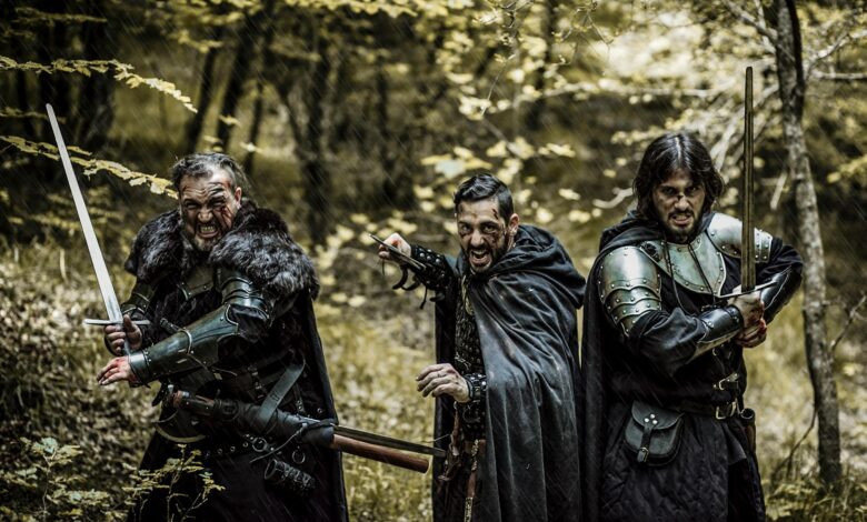 Three men in medieval armor and swords standing in a forest, ready for battle.