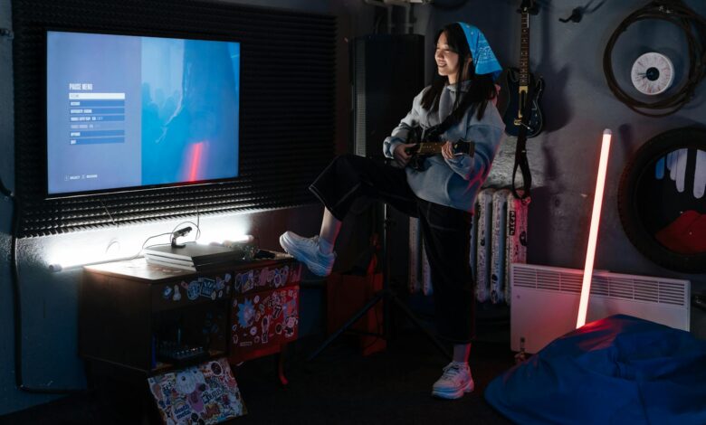 A young woman plays guitar in a stylish room with neon lighting and a wall-mounted screen.