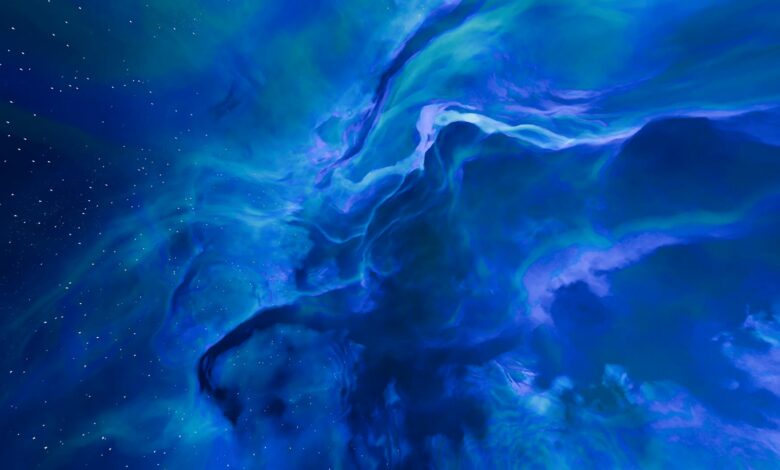 A stunning abstract of a blue and purple nebula in space, featuring swirling patterns and vivid colors.