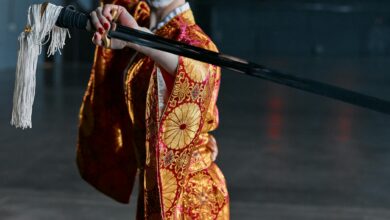 A woman in an ornate kimono brandishing a katana, exuding elegance and strength.