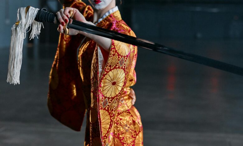 A woman in an ornate kimono brandishing a katana, exuding elegance and strength.