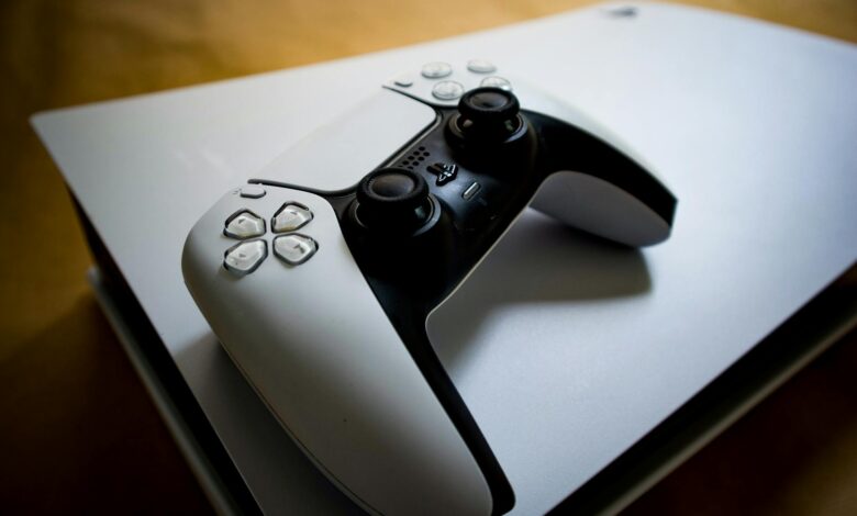Detailed shot of a PlayStation 5 controller resting on the console, highlighting modern gaming design.