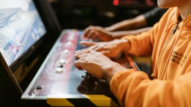 Close-up of hands at an arcade machine. Engaging in gaming, technology and recreation.