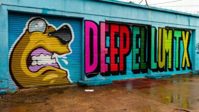 Colorful graffiti featuring bold text and cartoon design on urban garage doors.