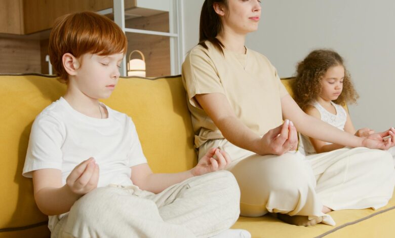 Family practicing meditation together on a couch, promoting mindfulness and relaxation.