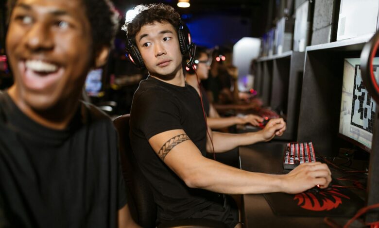 Young gamers engaged in a multiplayer session at an eSports arena with high-end gaming setups.