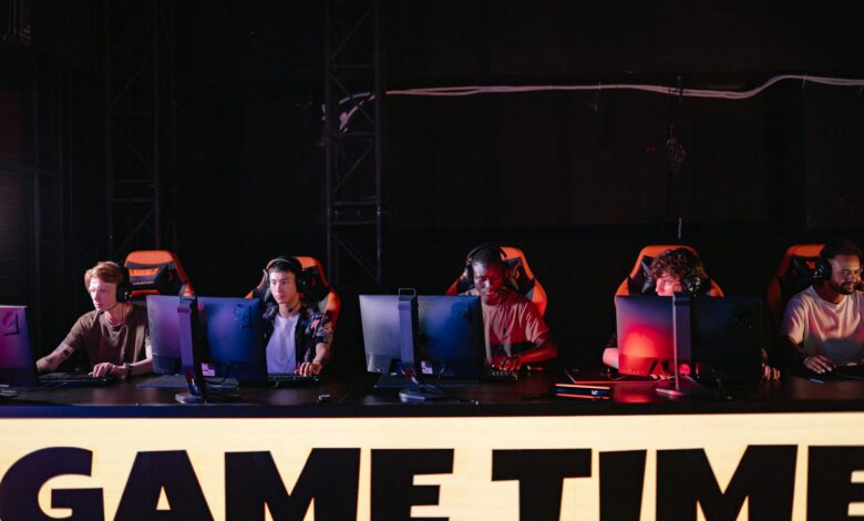 A group of diverse gamers participating in an online eSports tournament indoors.