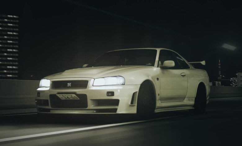 Stunning Nissan GT-R R34 captured driving through Tokyo's highways at night, showcasing its iconic design and headlights.