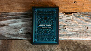 Blue Star Wars themed playing cards on a textured wooden surface.