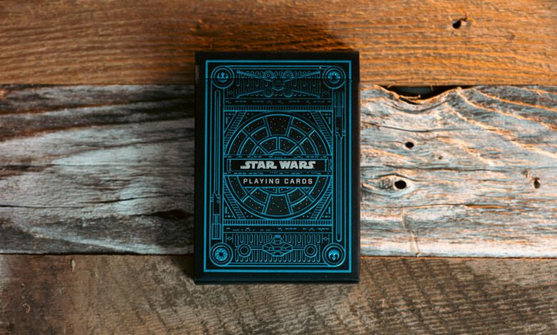 Blue Star Wars themed playing cards on a textured wooden surface.
