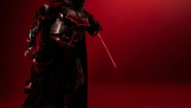 Detailed Batman cosplay in red-black theme, captured with dramatic lighting and mood.