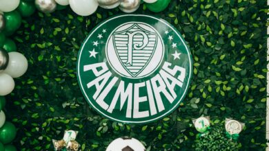 Green and white Palmeiras themed backdrop with balloons and football decorations.