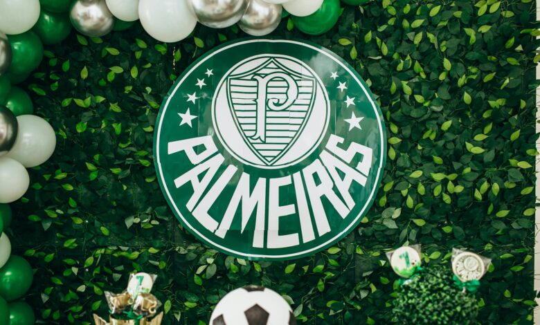 Green and white Palmeiras themed backdrop with balloons and football decorations.