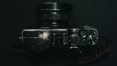 A top view of a vintage camera with dials on a dark background, showcasing retro design.