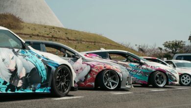 Unique street cars with anime vinyl art parked outdoors in Tokyo, ideal for showcasing vibrant car culture.