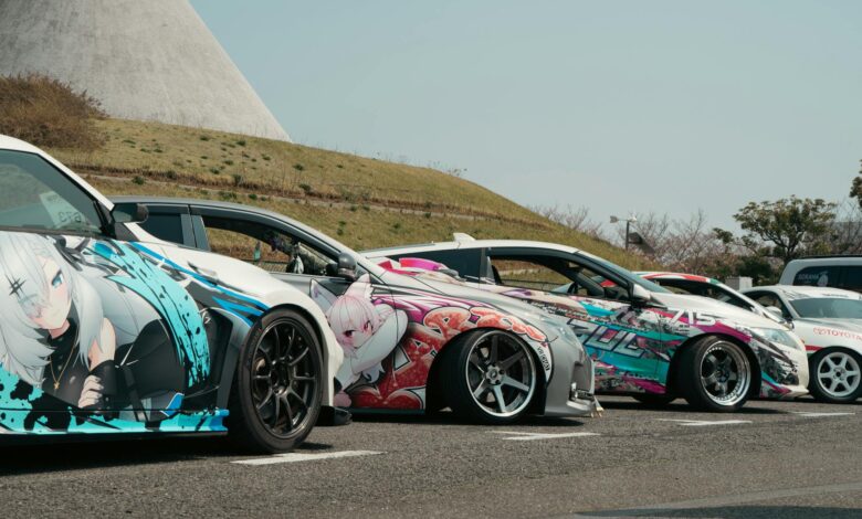 Unique street cars with anime vinyl art parked outdoors in Tokyo, ideal for showcasing vibrant car culture.