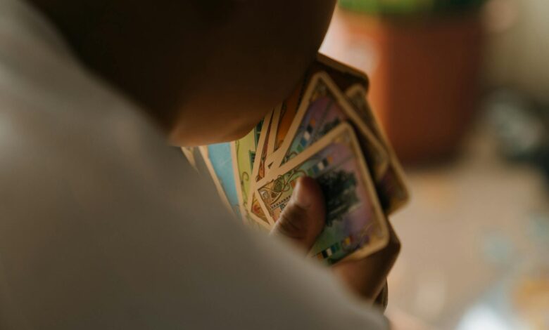 A child engaged in playing a card game indoors, focused on strategy and fun.