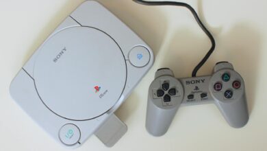 Close-up view of a retro Sony PlayStation One console with controller, ideal for game nostalgia enthusiasts.
