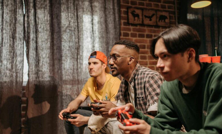 Three men focused on playing video games with controllers indoors.