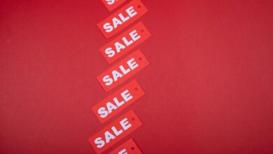 Red sale tags aligned diagonally on a red background, perfect for retail promotions.