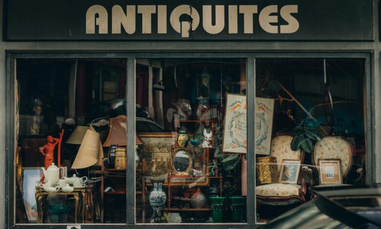 Explore a quaint Parisian antique shop with an elegant window display showcasing vintage treasures.