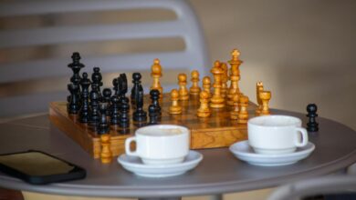 A chess board setup on a cafe table with two cups of coffee, ready for a casual game.