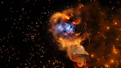 Bright fireworks exploding in vivid colors against a night sky.