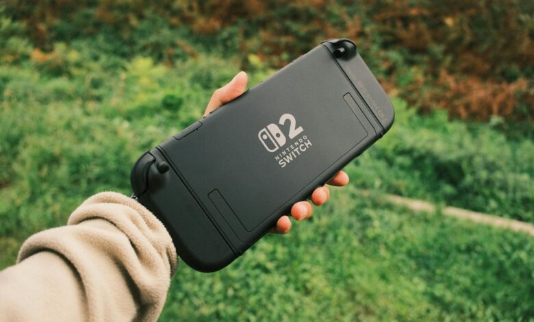 Person holding a Nintendo Switch in a natural outdoor setting, perfect for on-the-go gaming.
