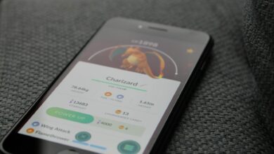 Smartphone displaying Pokémon GO screen with Charizard, highlighting gaming technology.