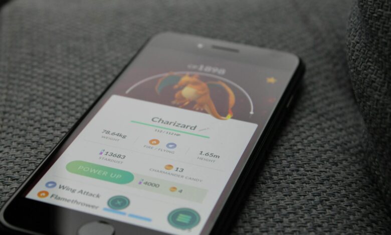Smartphone displaying Pokémon GO screen with Charizard, highlighting gaming technology.