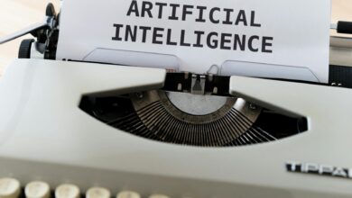 A close-up of a typewriter showcasing 'ARTIFICIAL INTELLIGENCE' on paper.