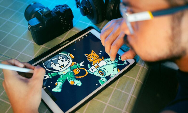 Person drawing digital art on a tablet using a stylus next to camera and headphones.