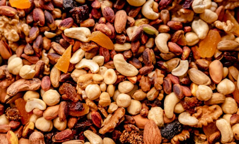 Close-up of assorted nuts and dried fruits creating a colorful, nutritious mix.