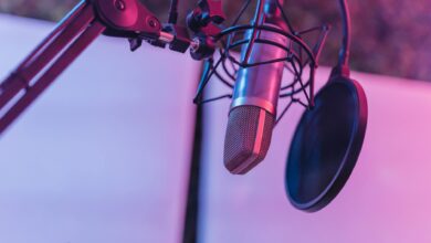 A close-up view of a microphone in a vibrant studio environment, ideal for podcasts and voice recording.