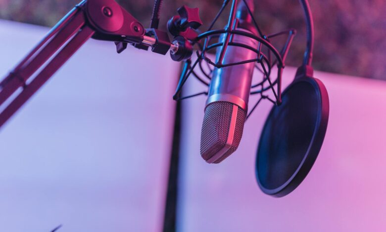 A close-up view of a microphone in a vibrant studio environment, ideal for podcasts and voice recording.