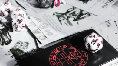 A close-up view of tabletop gaming cards and colorful dice, perfect for game enthusiasts.