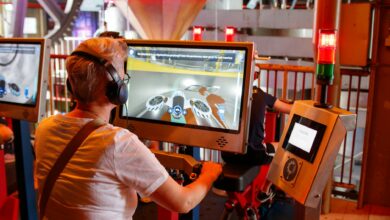 Individual using interactive simulator at a tech exhibit indoors.