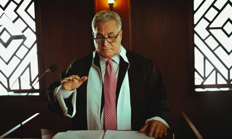 Mature male judge in a courtroom taking an oath, Baghdad, Iraq.