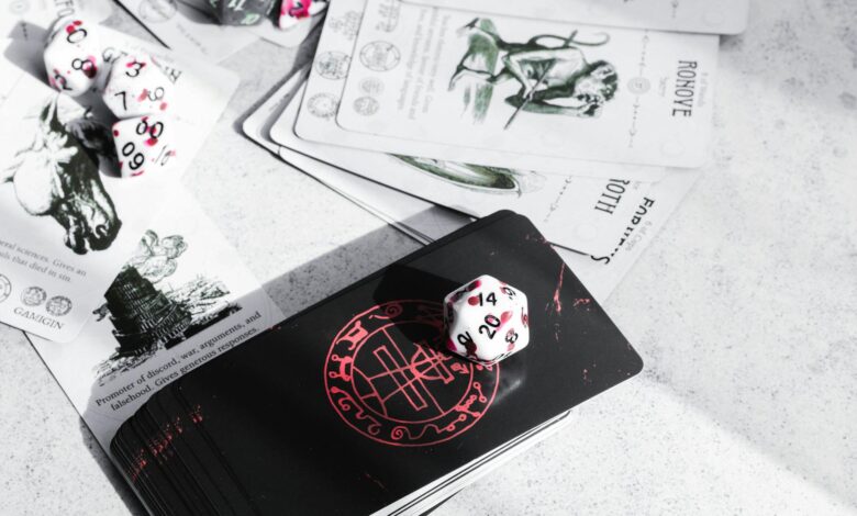 A collection of tarot cards and gaming dice on a tabletop, featuring mystical illustrations.