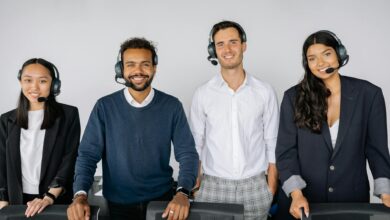 A diverse group of customer service representatives wearing headsets in a modern office.