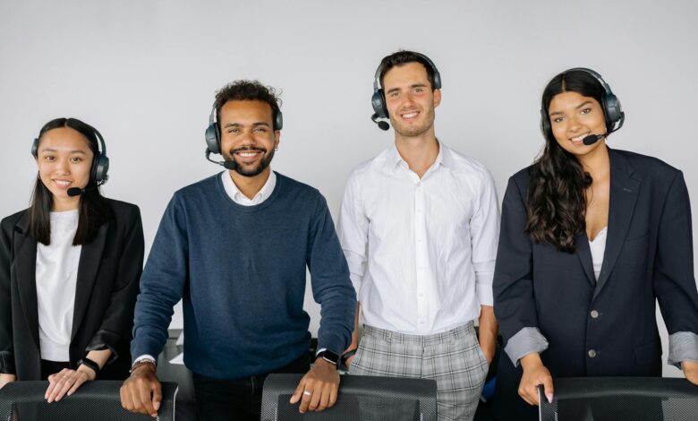 A diverse group of customer service representatives wearing headsets in a modern office.