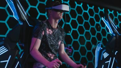 An adult male enjoying a virtual reality game in an arcade setting with futuristic elements.