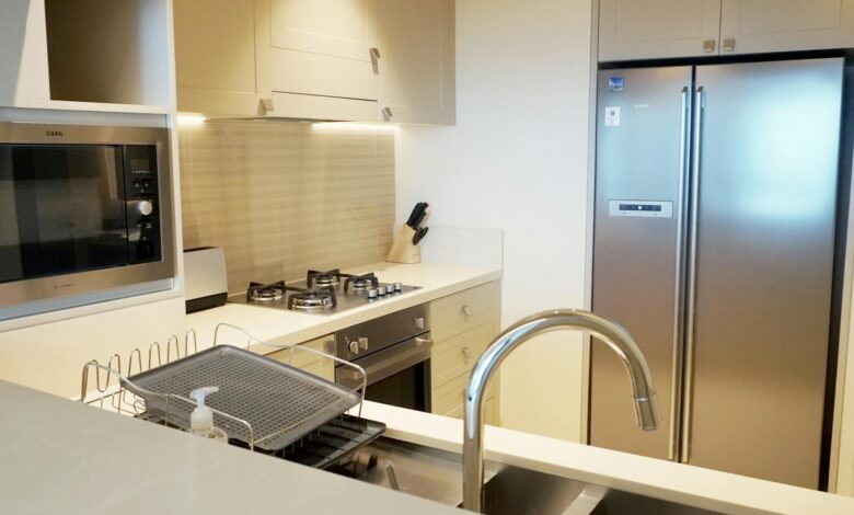 A stylish modern kitchen featuring stainless steel appliances and sleek design elements.