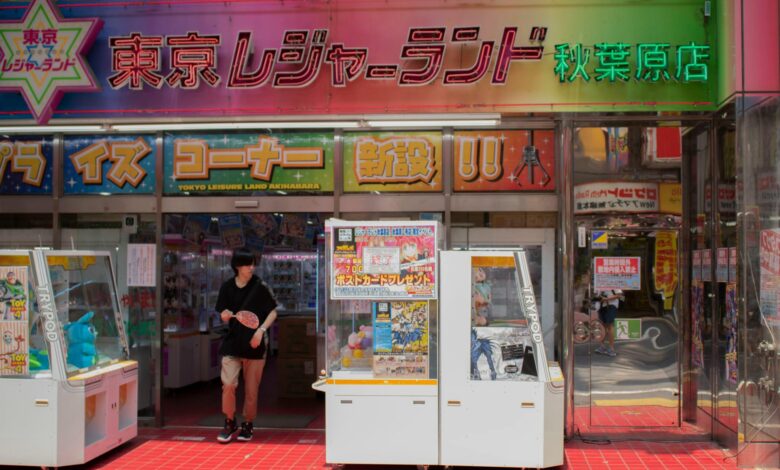 Entrance of Tokyo Leisureland arcade in Akihabara, showcasing gaming machines and vibrant signs.