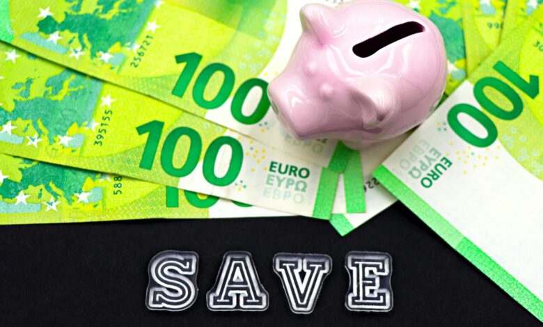 A piggy bank on euro bills with 'save' text highlights money saving concepts.
