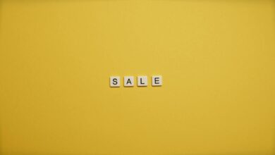 Single word 'SALE' spelled with tiles on a bright yellow background, ideal for advertising.