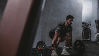 Man lifting weights in gym, displaying strength and focus. Ideal for fitness and training themes.