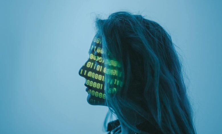 Silhouette of a woman with binary code projected on her face in a digital concept setting.